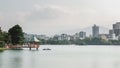 Fukuoka, Japan - A boat and a hexagonal, vermilion pavilion on a large pond at Ohori Park.